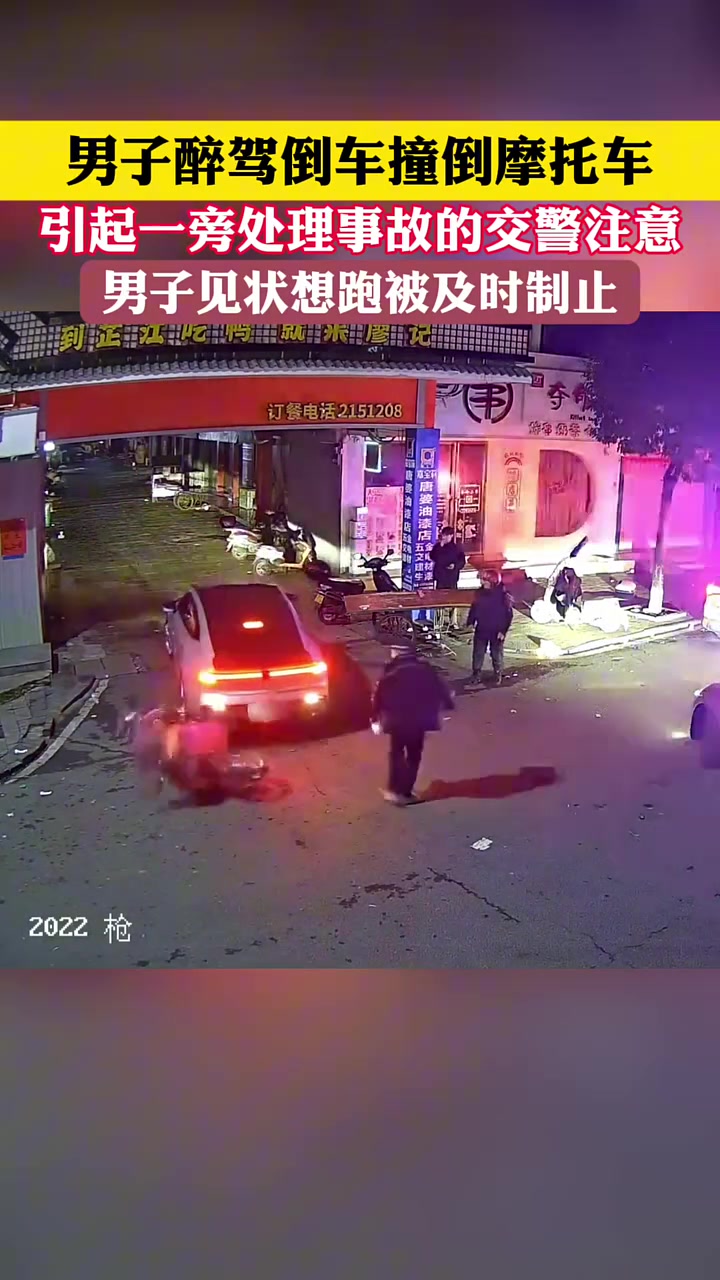 男子酒驾倒车撞倒摩托车，引起一旁处理事故的交警注意！